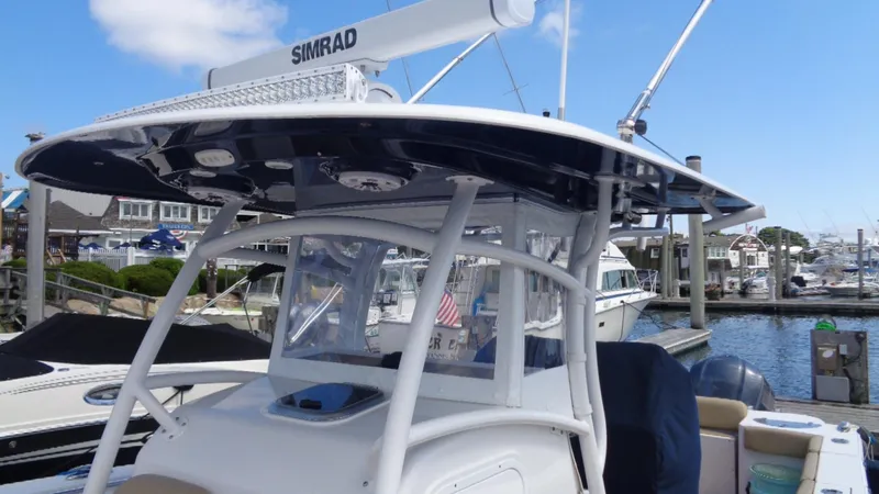 Slide: The Image of 2017 Sportsman 312 Open boat with Simrad radar, docked at a marina. - 3