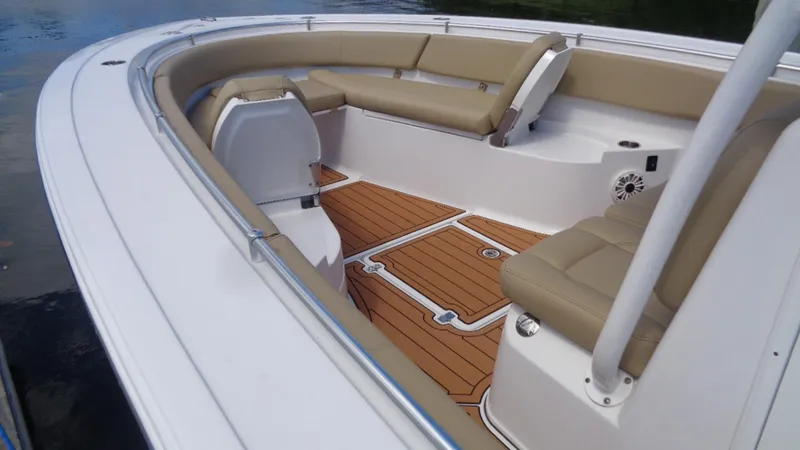 Slide: The Image of 2017 Sportsman 312 Open boat interior with cushioned seating and wood-style flooring. - 4