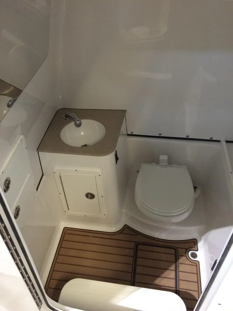 Slide: The Image of 2017 Sportsman 312 Open boat bathroom with sink and toilet. - 6