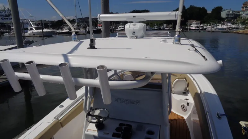 Slide: The Image of 2017 Sportsman 312 Open boat with T-top and rod holders at marina. - 8
