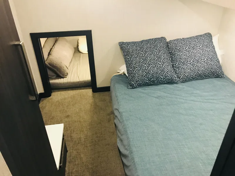 Slide: The Image of Cozy bedroom in 2018 Adonia Adonis Trip 3 with blue bedding and patterned pillows. - 13