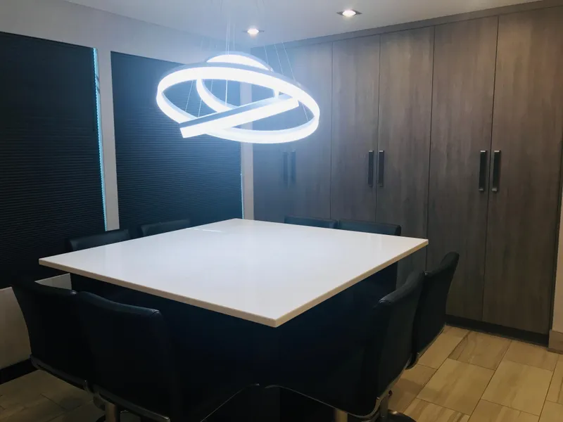 Slide: The Image of Modern dining room with square table, stylish chairs, and unique circular light fixture. - 21