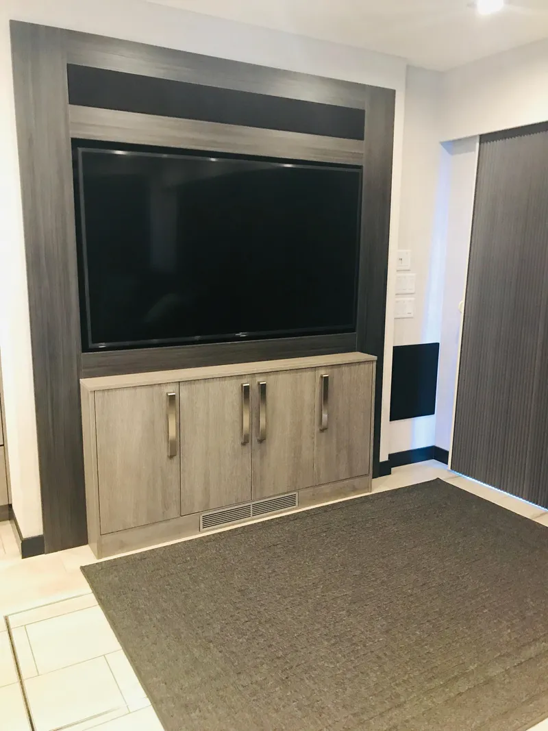 Slide: The Image of Modern entertainment center with large TV and sleek cabinetry in a stylish living space. - 25