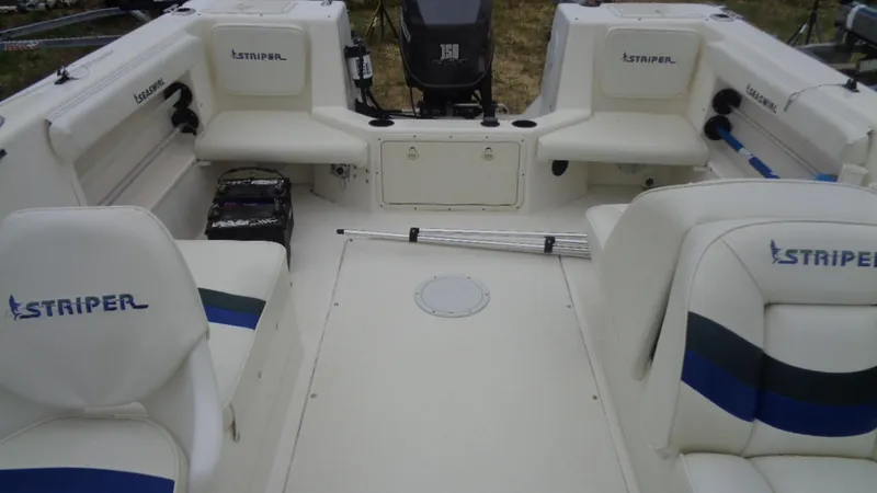Slide: The Image of 1999 Seaswirl Striper 21 DC boat interior with seating and storage compartments. - 11