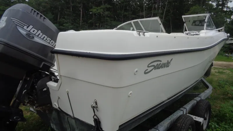 Slide: The Image of 1999 Seaswirl Striper 21 DC boat with Johnson outboard motor on trailer. - 15