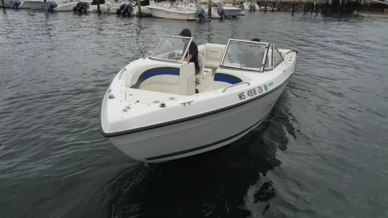 Slide: The Image of 1999 Seaswirl Striper 21 DC boat on water, white hull, dual console design. - 3