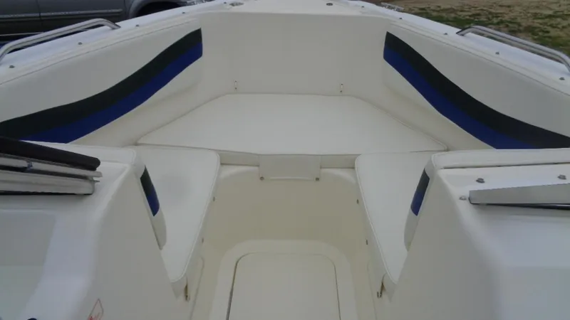 Slide: The Image of 1999 Seaswirl Striper 21 DC boat interior with white seating and blue accents. - 5