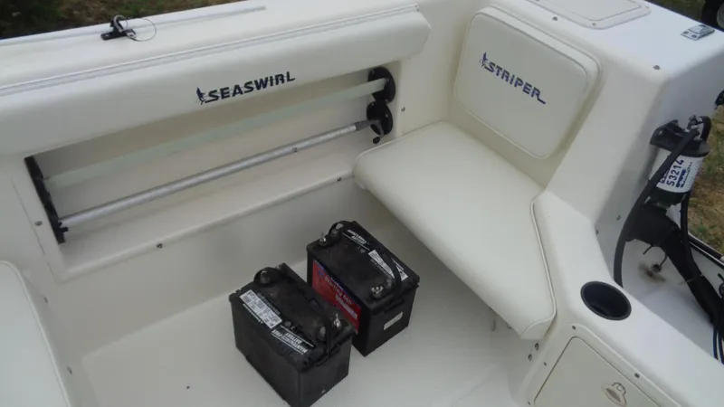 Slide: The Image of 1999 Seaswirl Striper 21 DC boat interior with batteries and seating area. - 9