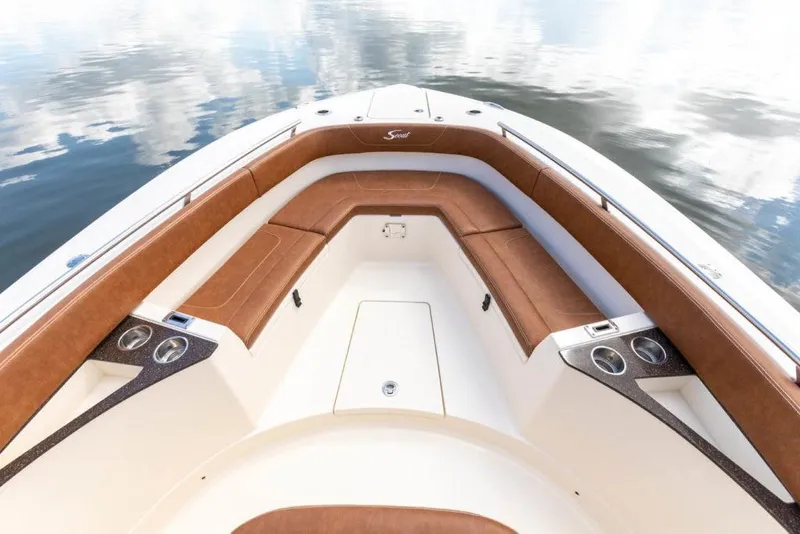 Slide: The Image of 2023 Scout 277 LXF boat with luxurious brown seating and cup holders. - 10