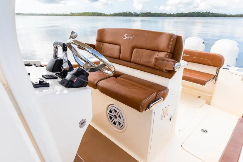 Slide: The Image of 2023 Scout 277 LXF boat interior with brown leather seats and steering wheel. - 20