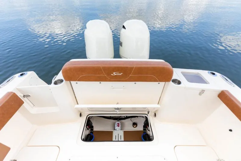 Slide: The Image of 2023 Scout 277 LXF boat stern with twin engines and storage compartment. - 24