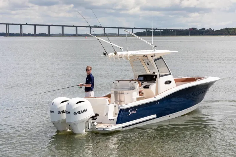 Slide: The Image of 2023 Scout 277 LXF boat with dual Yamaha engines on the water. - 6