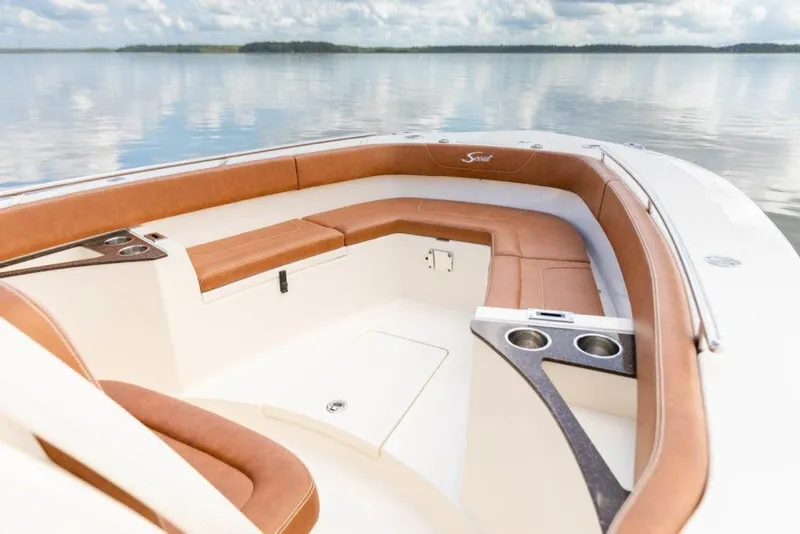 Slide: The Image of 2023 Scout 277 LXF boat interior with tan seating and cup holders. - 9