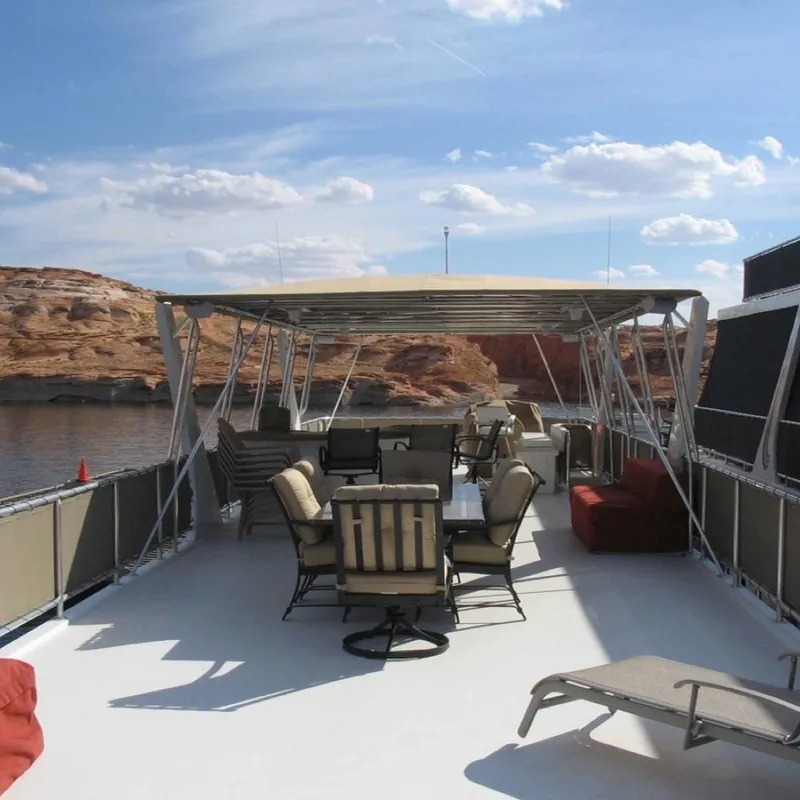 Slide: The Image of 2007 Stardust Cruisers Sundancer Trip 7 houseboat deck with seating, under a clear blue sky. - 11