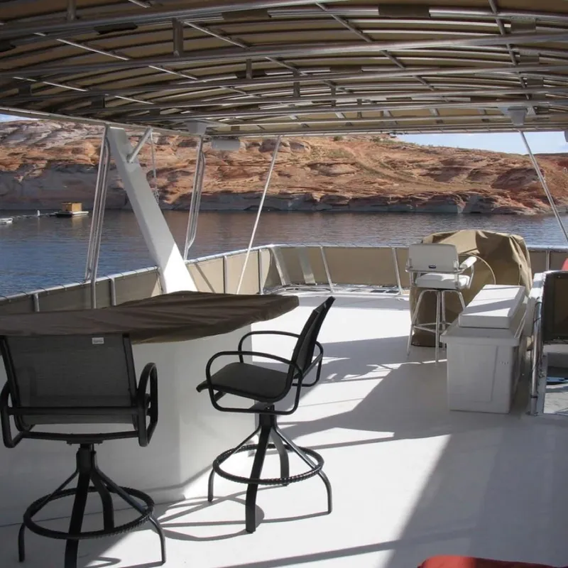 Slide: The Image of 2007 Stardust Cruisers Sundancer Trip 7 yacht deck with seating, overlooking scenic water and cliffs. - 12