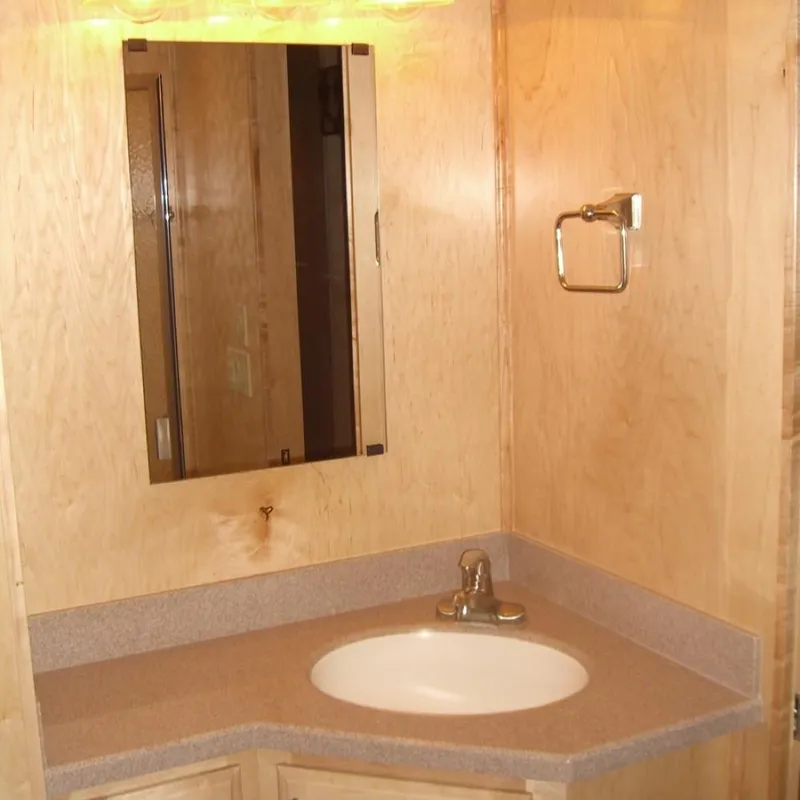 Slide: The Image of 2007 Stardust Cruisers Sundancer bathroom with wooden vanity, mirror, and sink. - 8