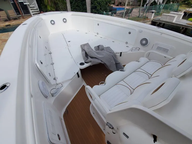 Slide: The Image of 2008 Everglades 350 CC boat interior with white seating and spacious deck. - 13