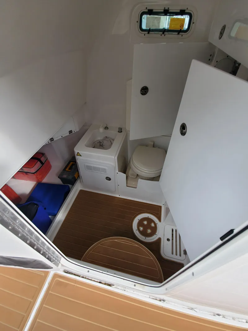 Slide: The Image of 2008 Everglades 350 CC boat interior with toilet and storage compartments. - 15