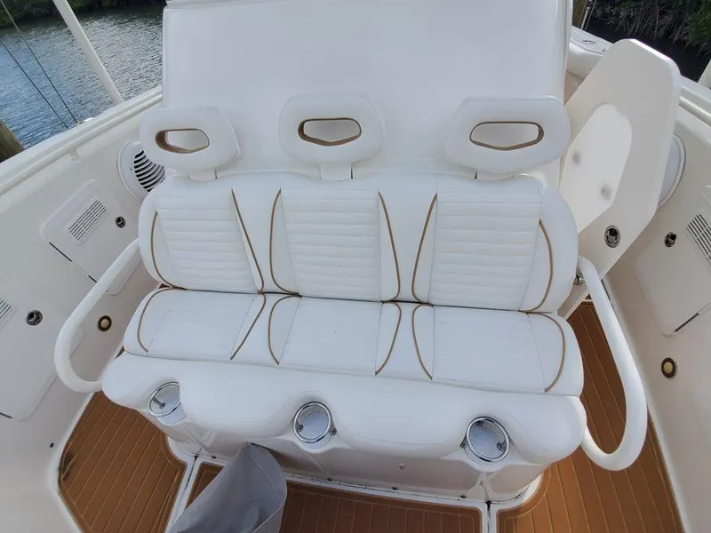 Slide: The Image of 2008 Everglades 350 CC boat seating with white cushioned seats and cup holders. - 29