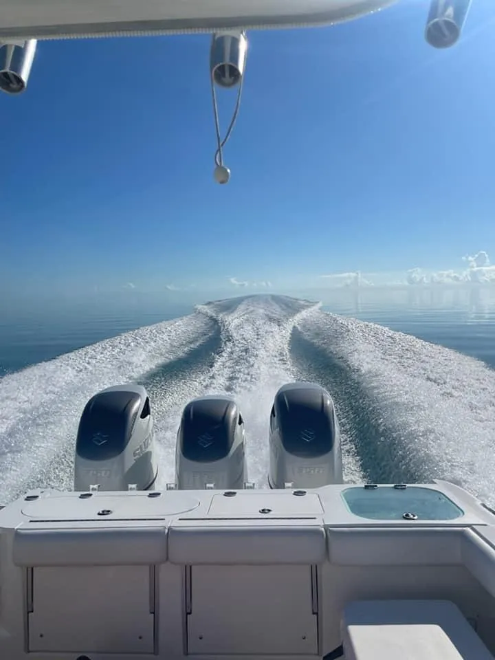 Slide: The Image of Everglades 350 CC 2008 boat cruising on calm ocean with triple engines. - 3