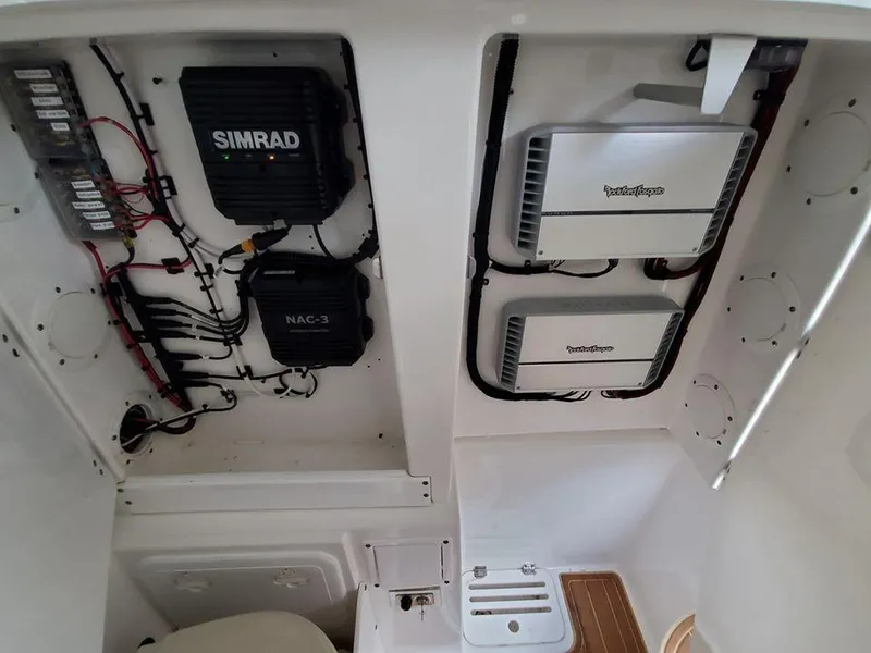 Slide: The Image of 2008 Everglades 350 CC boat electronics compartment with Simrad and Fusion equipment. - 35