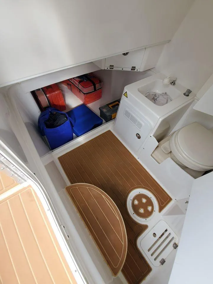 Slide: The Image of 2008 Everglades 350 CC boat interior with storage and marine toilet. - 37