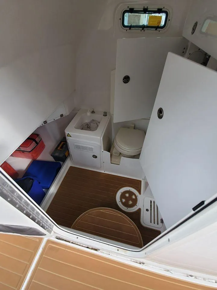 Slide: The Image of 2008 Everglades 350 CC boat interior with toilet and storage compartments. - 38