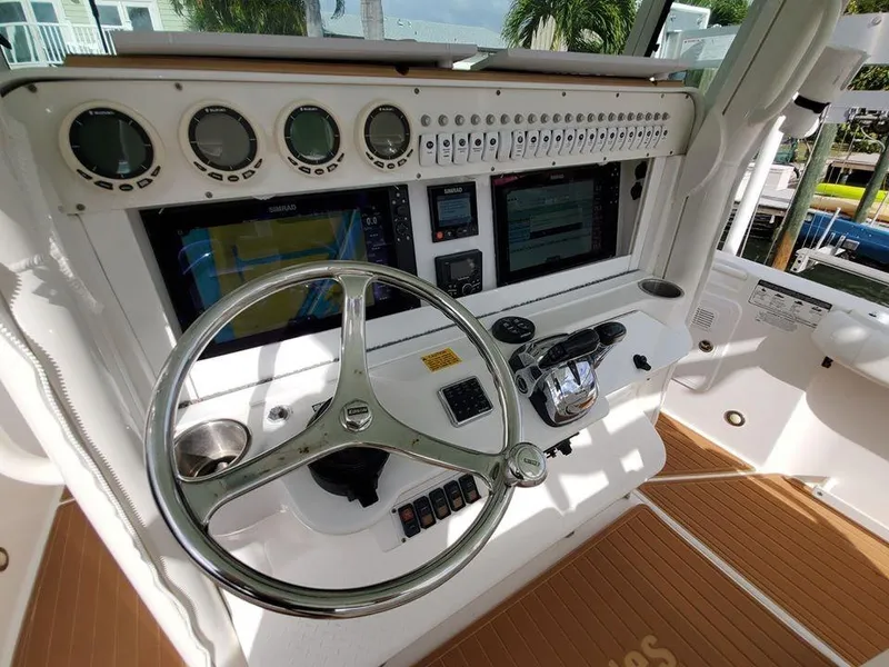 Slide: The Image of 2008 Everglades 350 CC boat dashboard with steering wheel and navigation instruments. - 39