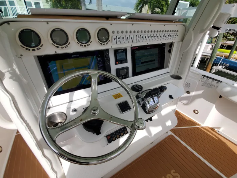 Slide: The Image of Control panel of a 2008 Everglades 350 CC boat with steering wheel and navigation instruments. - 4