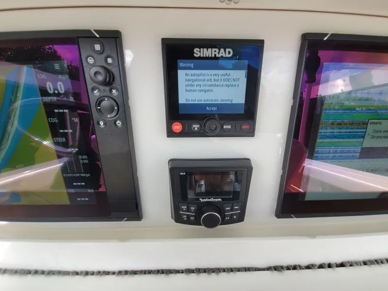 Slide: The Image of 2008 Everglades 350 CC boat dashboard with Simrad navigation system and displays. - 47