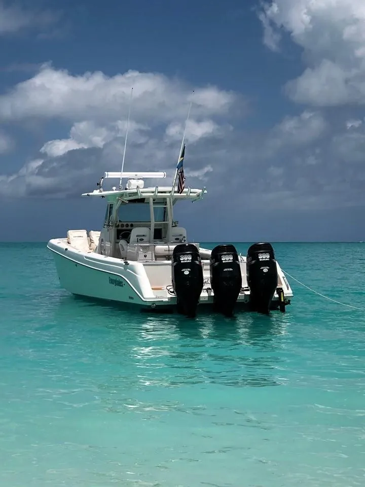Slide: The Image of 2008 Everglades 350 CC boat anchored in clear turquoise water. - 8