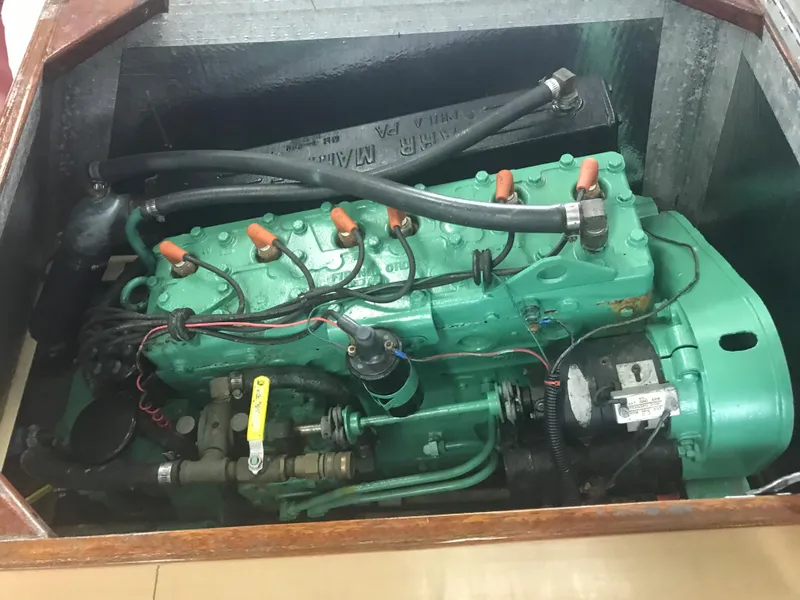 Slide: The Image of 1957 Lyman Islander engine in a wooden compartment. - 12