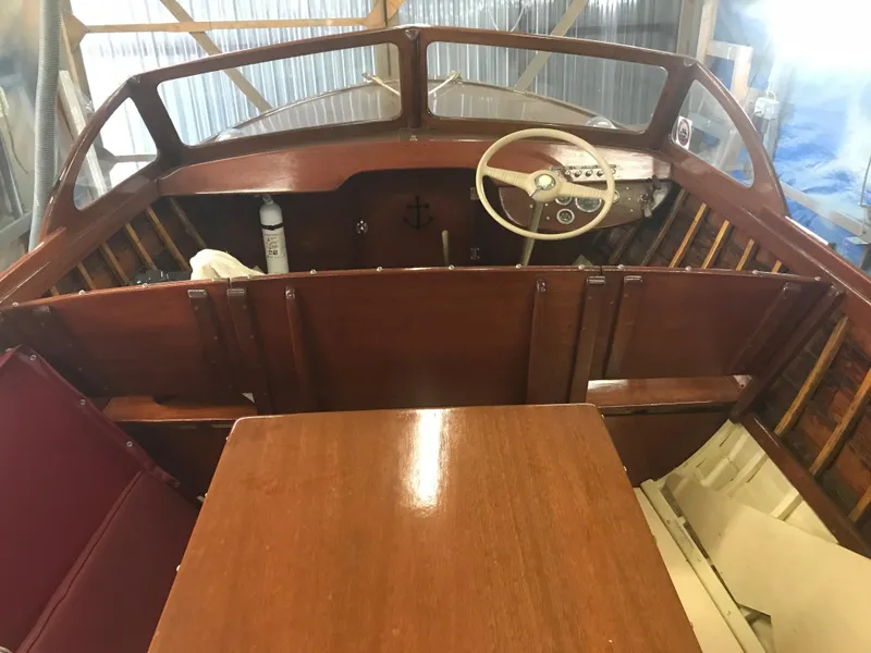 Slide: The Image of 1957 Lyman Islander boat interior with wooden dashboard and steering wheel. - 14