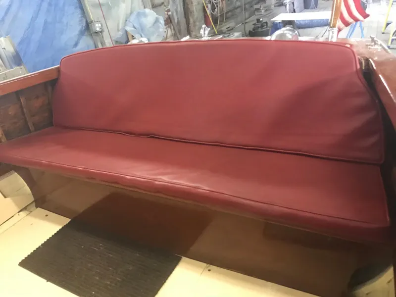 Slide: The Image of 1957 Lyman Islander boat with red leather bench seat. - 15