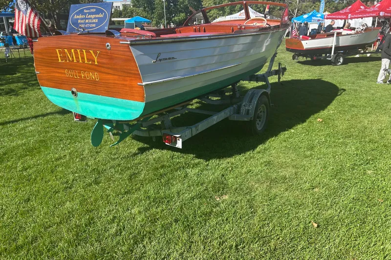 Slide: The Image of 1957 Lyman Islander boat named "Emily" on display, resting on a trailer. - 19