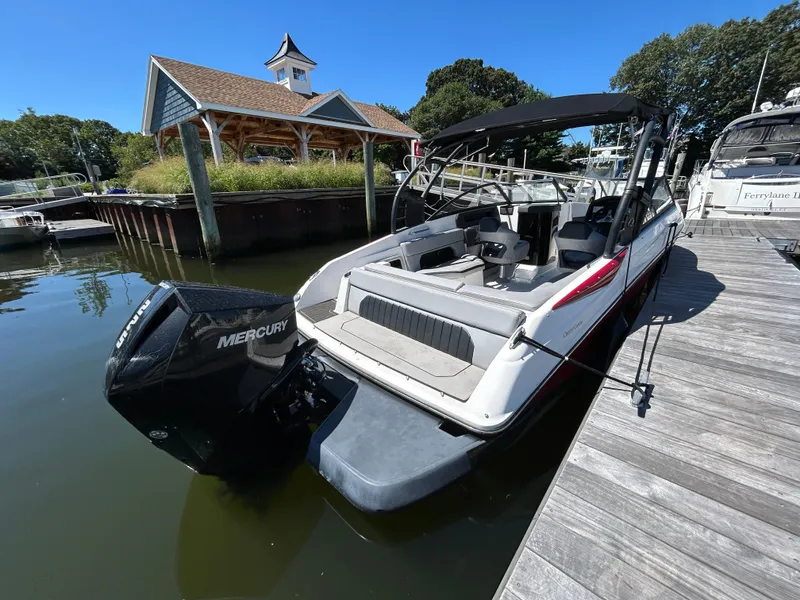 Slide: The Image of 2019 Rinker Q5 OB boat docked with Mercury outboard motor, sunny day. - 10
