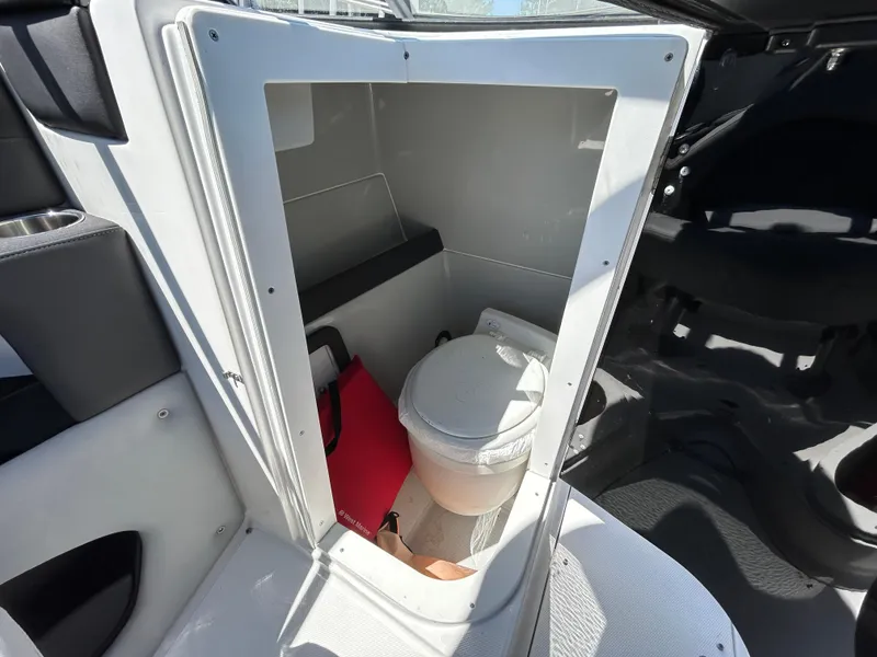 Slide: The Image of 2019 Rinker Q5 OB boat interior with compact marine toilet. - 15