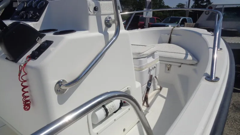 Slide: The Image of 1999 Boston Whaler 140 Dauntless boat interior with steering console and seating area. - 11