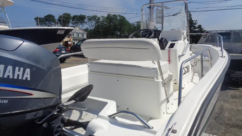 Slide: The Image of 1999 Boston Whaler 140 Dauntless boat with Yamaha engine, docked outdoors. - 12