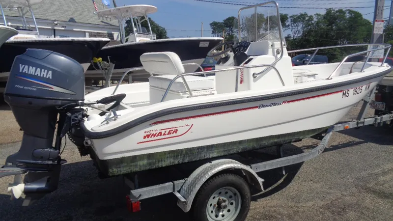 Slide: The Image of 1999 Boston Whaler 140 Dauntless boat on trailer with Yamaha outboard motor. - 2
