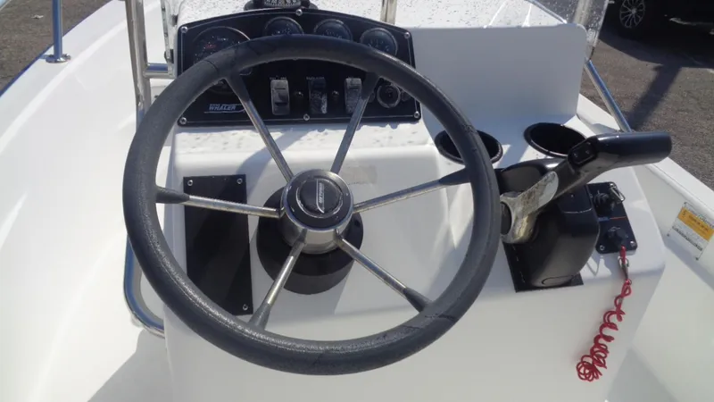 Slide: The Image of 1999 Boston Whaler 140 Dauntless steering console with gauges and controls. - 7
