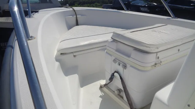 Slide: The Image of 1999 Boston Whaler 140 Dauntless boat interior with seating and cooler. - 8