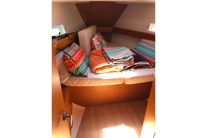 Slide: The Image of Cozy cabin interior of 2018 Jeanneau Sun Odyssey 419 with colorful bedding. - 12