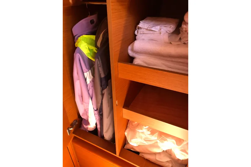 Slide: The Image of Closet in 2018 Jeanneau Sun Odyssey 419 with jackets and neatly folded towels. - 14