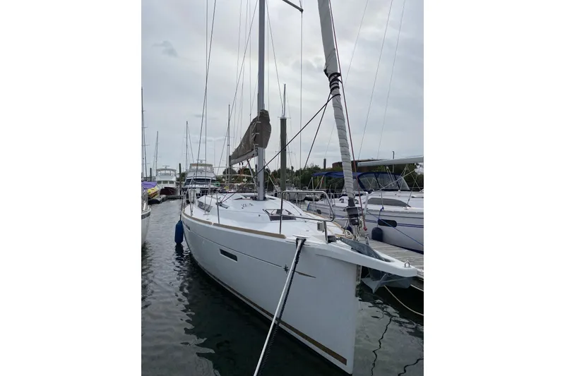 Slide: The Image of 2018 Jeanneau Sun Odyssey 419 sailboat docked in marina, overcast sky. - 6