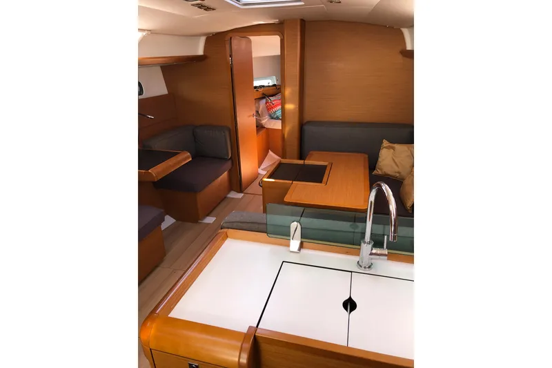 Slide: The Image of Interior of 2018 Jeanneau Sun Odyssey 419 sailboat, featuring modern wood finish and seating area. - 9