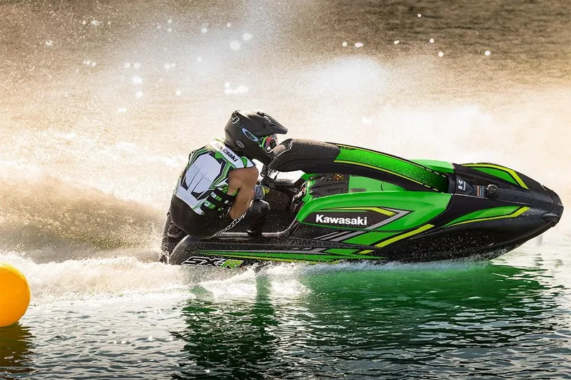 Slide: The Image of 2023 Kawasaki SX-R jet ski in action on water. - 2