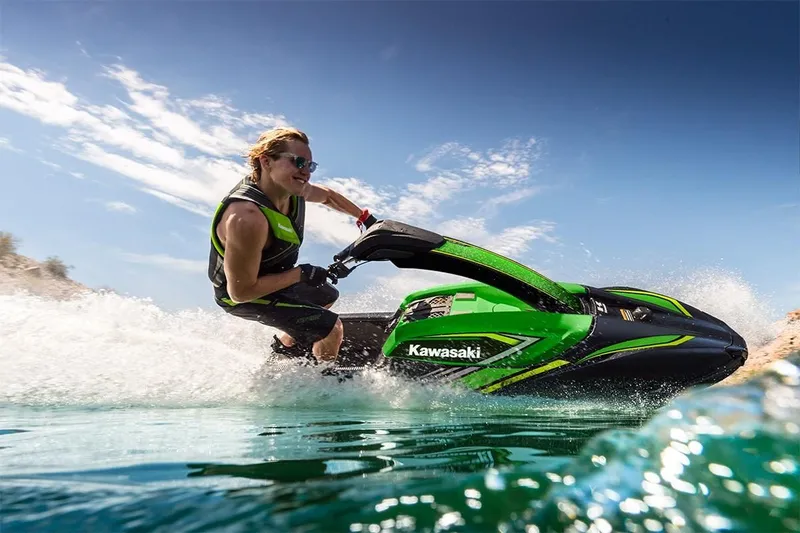 Slide: The Image of 2023 Kawasaki SX-R jet ski in action on the water. - 3