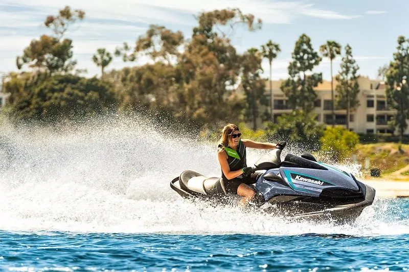Slide: The Image of 2023 Kawasaki Ultra LX jet ski in action on a sunny day. - 4
