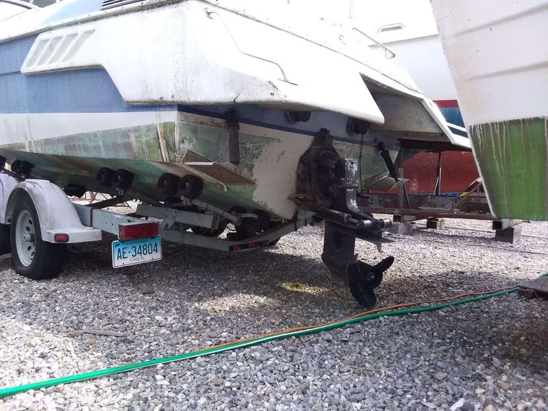 Slide: The Image of 1988 Wellcraft 23 NOVA XL boat on trailer, showing stern and propeller. - 11